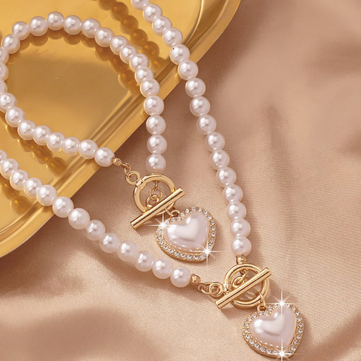 Conjunto de pulseira e colar com pendente em forma de coração em pérolas de 2 peças